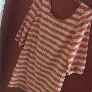 Orange and white chevron slim dress, lower thigh.